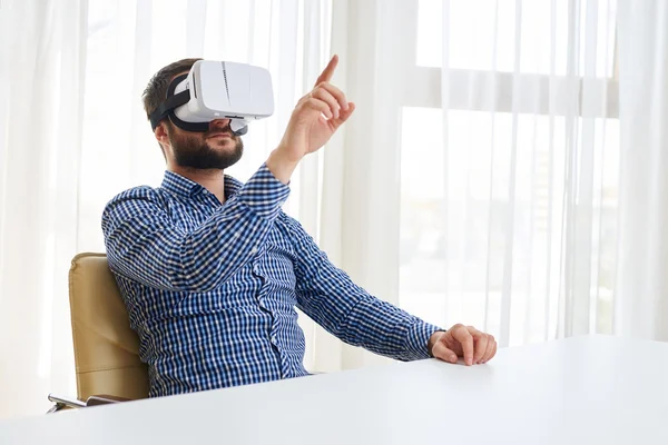 Young man is pointing at something in virtual reality — Stock Photo, Image