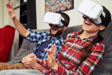 Couple in virtual reality glasses surprised by virtual reality h