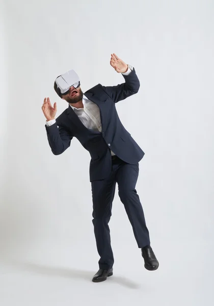 Businessman in a formal wear afraid of using white virtual reali — Stock Photo, Image