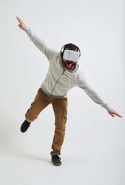 Man balancing on one leg in 3d glasses