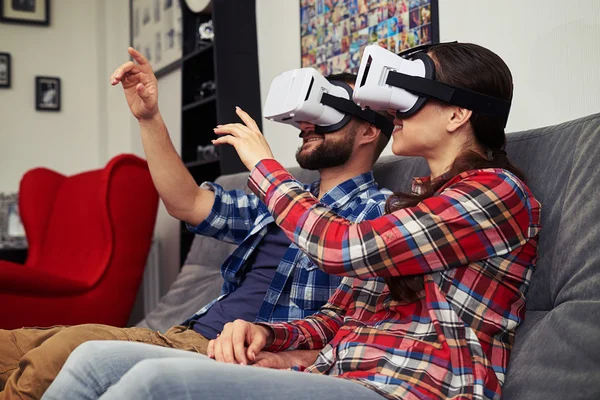 Couple in virtual reality glasses watching something and trying — Stock Photo, Image
