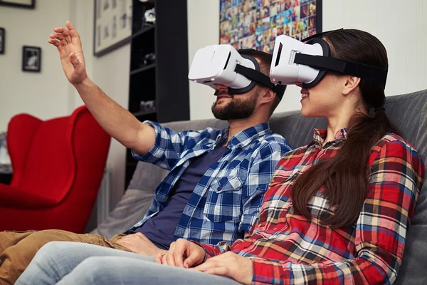 Couple in virtual reality glasses watching something and man try — Stock Photo, Image