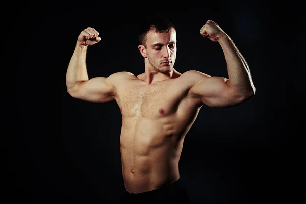 Hot guy with abs and biceps over black background — Stock Photo, Image