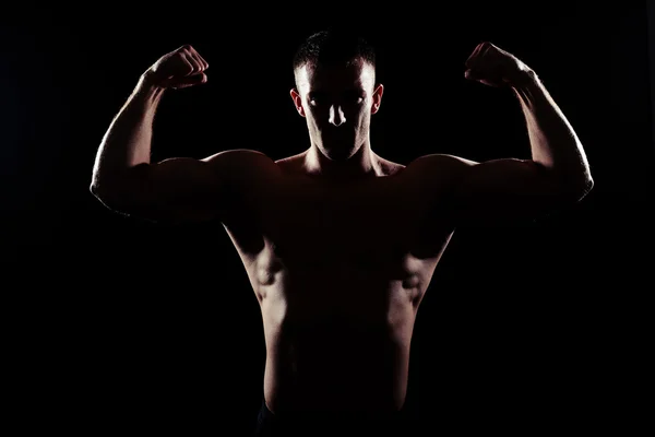 Silhouette of sexy athletic man on black background — Stock Photo, Image