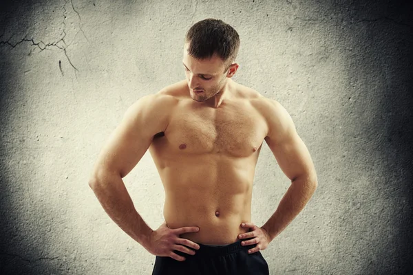 Athletic man with bare chest looking down — Stock Photo, Image