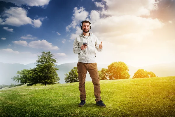 Man on a lawn showing thumb up gesture — Stock Photo, Image