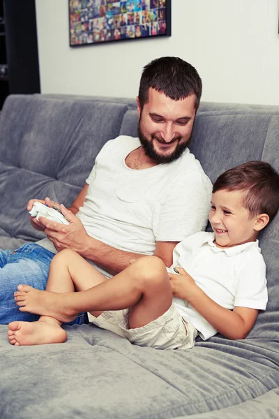 Papa et fils s'amusent à jouer au jeu vidéo en utilisant des joysticks — Photo