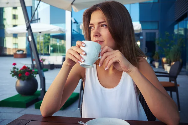 Porträt einer schönen jungen Frau im Straßencafé, die Kaffee trinkt — Stockfoto