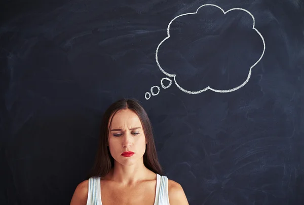 A frown of concentration settles over her eyes — Stock Photo, Image