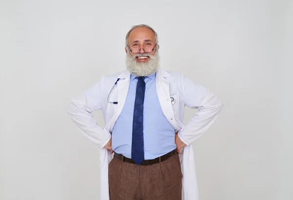 Close-up portrait of smiling mature bearded doctor with hands on — Stock Photo, Image