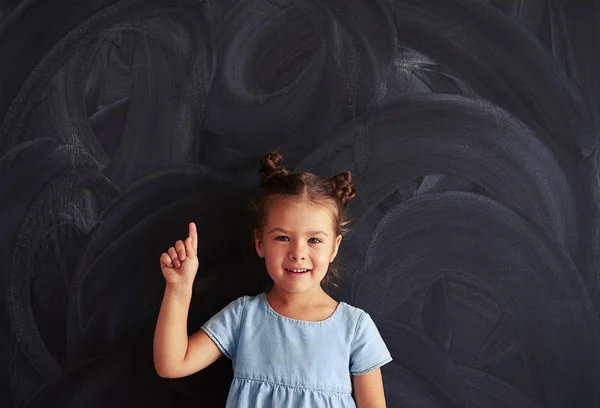 Small princess with a cute haircut showing finger on the top — Stock Photo, Image