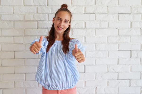 Smiling elated girl with thumbs-up — Stock Photo, Image