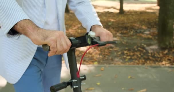 Homem montando scooter elétrico no parque — Vídeo de Stock