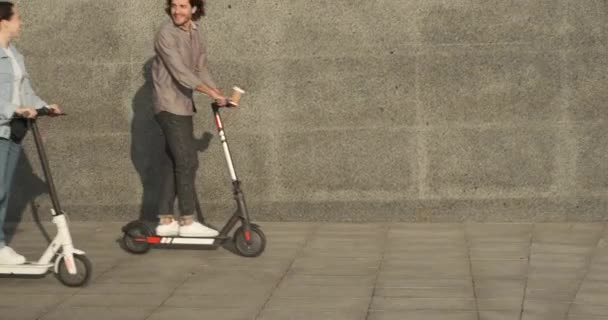 Casal usando scooter elétrico na cidade — Vídeo de Stock