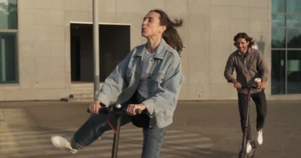 Pareja disfrutando de montar scooter eléctrico en la ciudad — Vídeo de stock