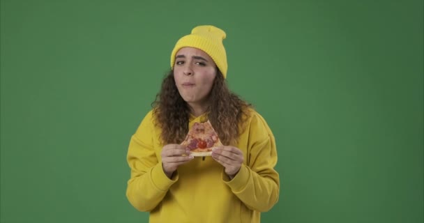 Жінка їсть смачний шматочок піци і дає великі пальці вгору — стокове відео
