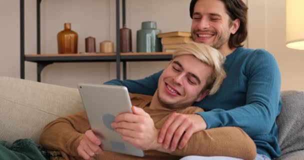 Gay couple using digital tablet at home — Stock Video