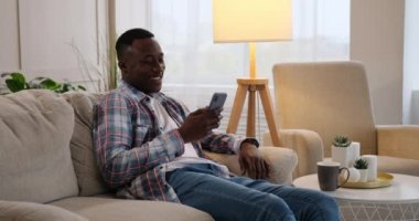 Evde cep telefonu kullanan bir adam görüntüsü sohbet ediyor.