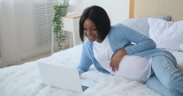 Έγκυος γυναίκα που χρησιμοποιεί φορητό υπολογιστή στο κρεβάτι — Αρχείο Βίντεο
