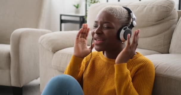Perempuan menyanyikan lagu dan mendengarkan musik di headphone — Stok Video