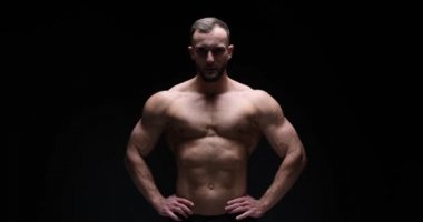 Man flexing muscles in studio