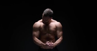 Man flexing muscles in studio