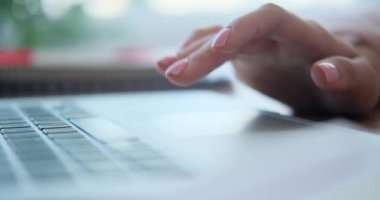 Woman using touchpad of laptop