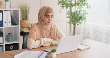 Ofiste dizüstü bilgisayarla iş görüşmesi yapan bir kadın.