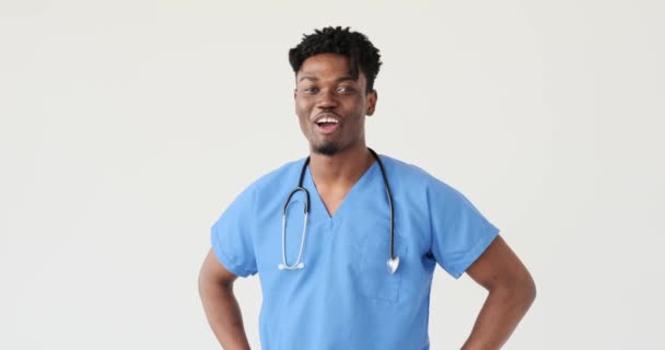 Male doctor laughing over white background — Stock Video