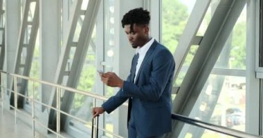 Havaalanında cep telefonu kullanan bir iş adamı.