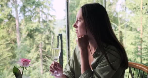 Young woman drinking champagne at restaurant — Stock Video