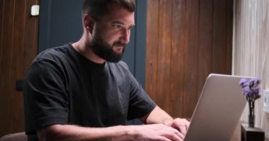 Adam gece geç saatte bilgisayar kullanıyor.