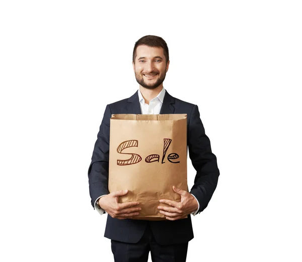 Handsome man holding shopping bag — Stock Photo, Image