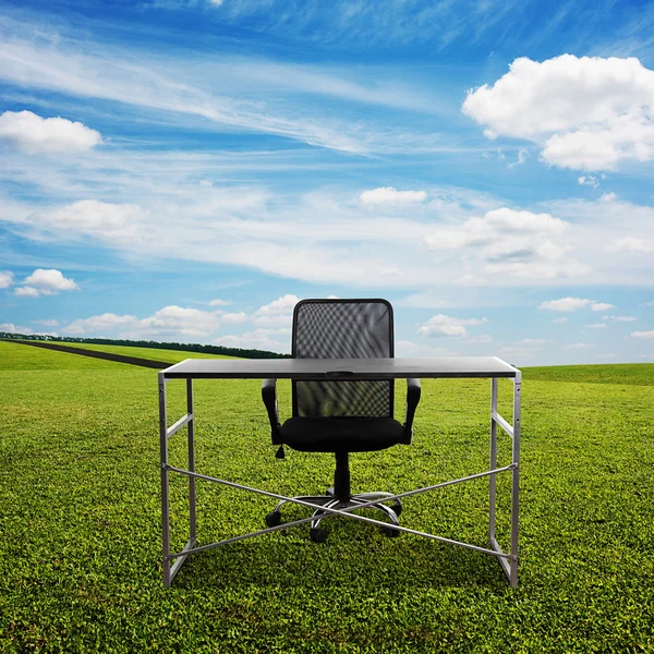 Table and chair on the meadow — Stock Photo, Image