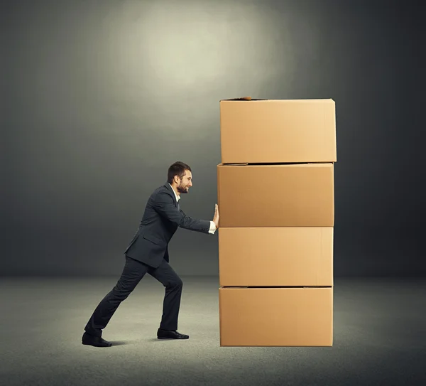 Smiley businessman with boxes — Stock Photo, Image