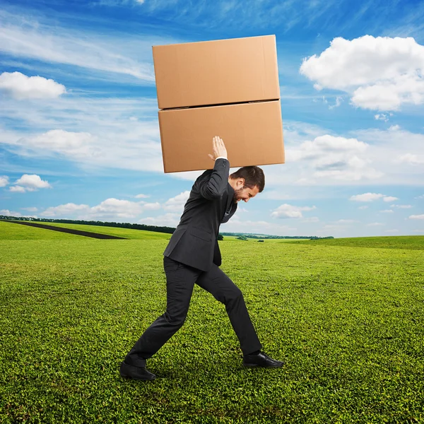 Businessman in suit carrying — Stock Photo, Image