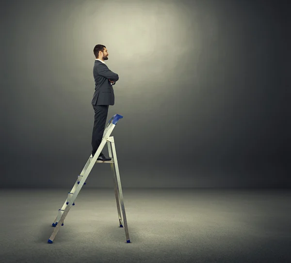 Businessman standing on the stepladder — Stock Photo, Image