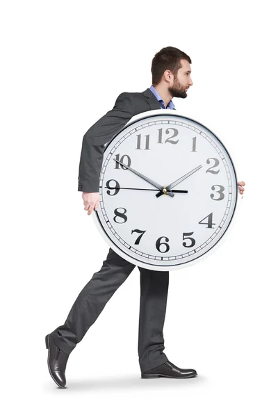 Homem sério segurando grande relógio — Fotografia de Stock