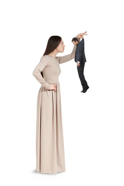 Woman to examining small man — Stock Photo, Image