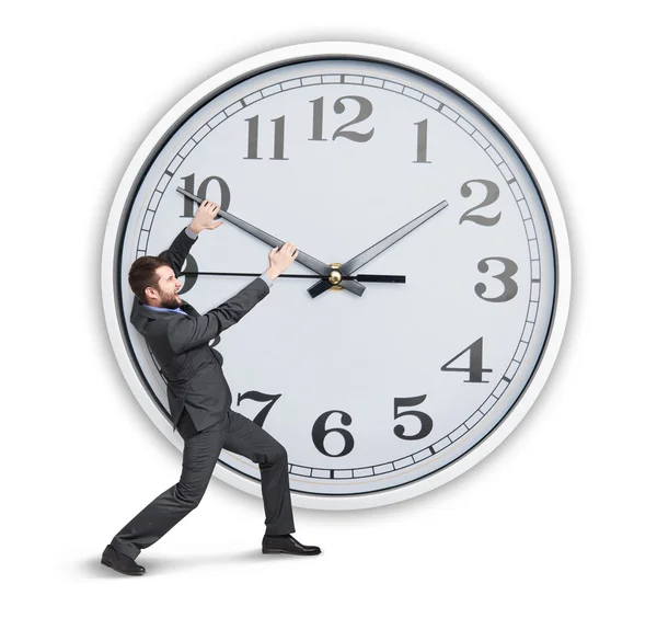 Young businessman trying to stop a time — Stock Photo, Image