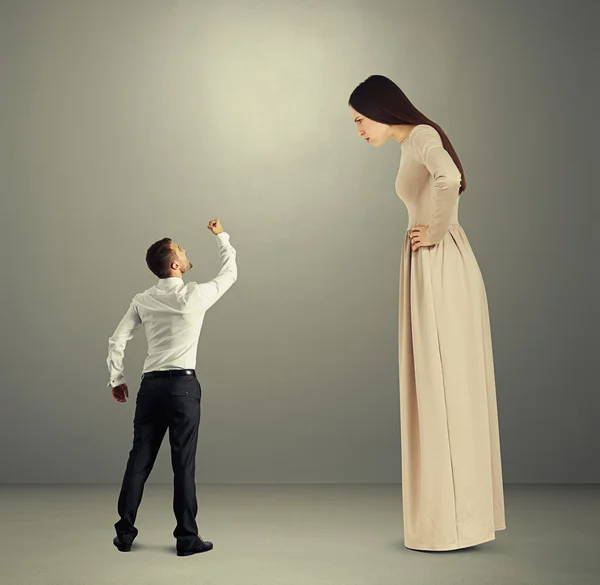 Man showing fist to dissatisfied woman — Stock Photo, Image