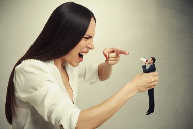 displeased woman holding small man clipart
