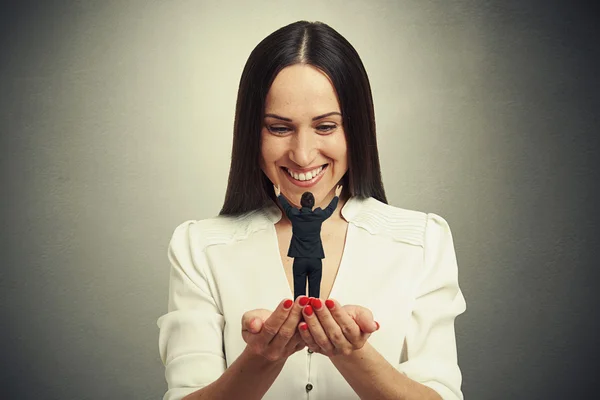 Woman holding small man on the palm — Stock Photo, Image