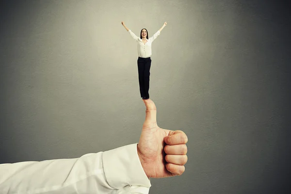 Woman standing on big thumbs up — Stock Photo, Image