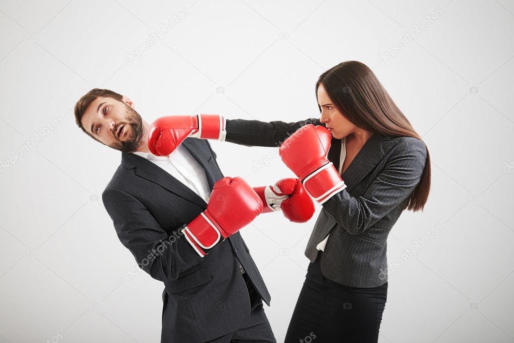woman punching businessman