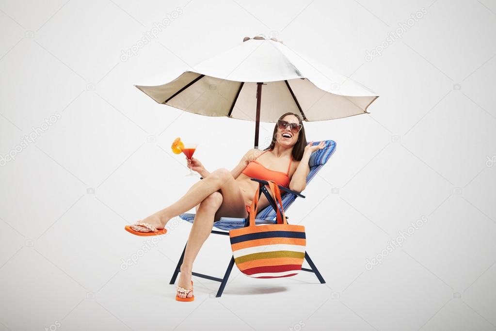 woman under beach umbrella
