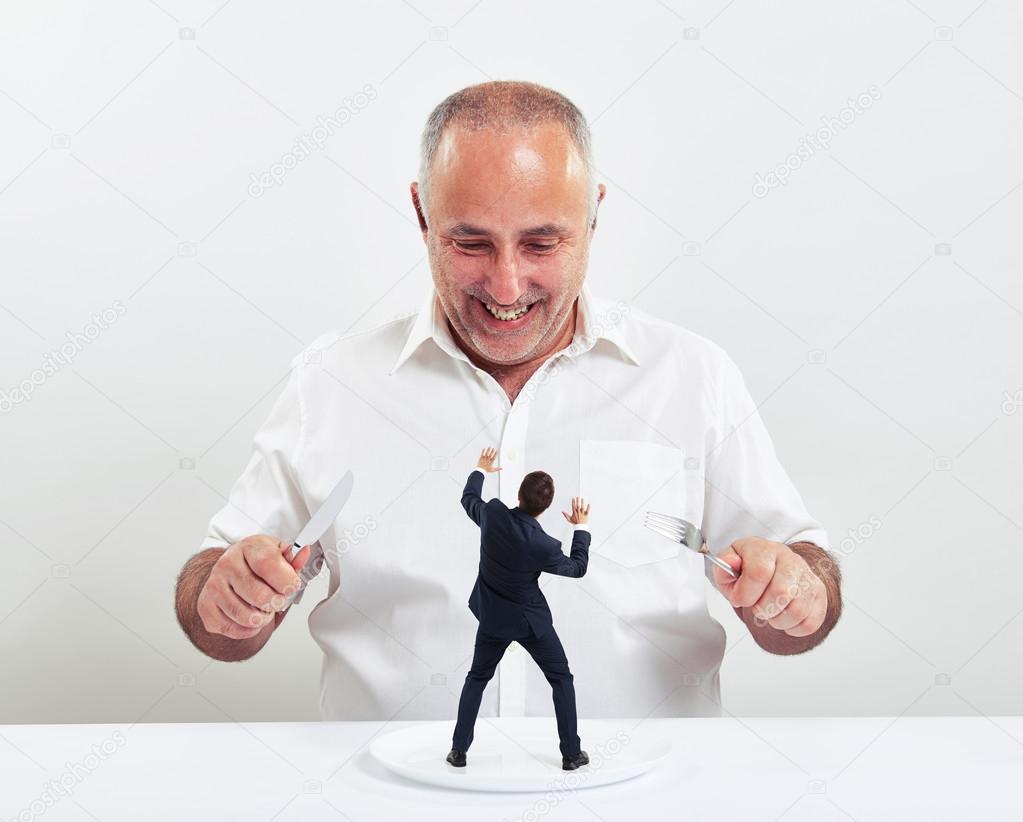 smiley senior man holding fork