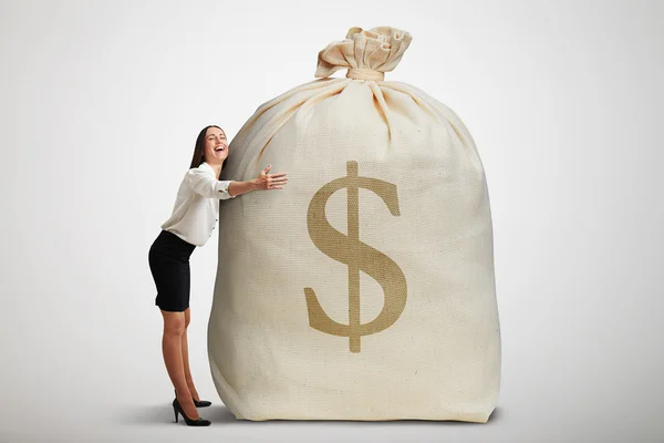 Woman embracing big bag — Stock Photo, Image