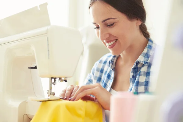 Seamstress sewing yellow dress — Stock Fotó