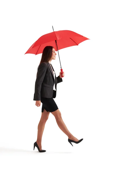 Woman walking under red umbrella — Stock Photo, Image